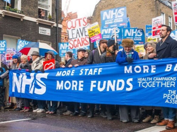 People holding NHS banner