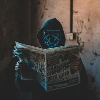 person wearing mask reading newspaper image sourced licence free from pexels