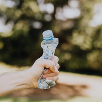 Hand squeezing a plastic bottle_stock image via Canva