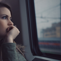 Woman looking out of window_stock image 200x200