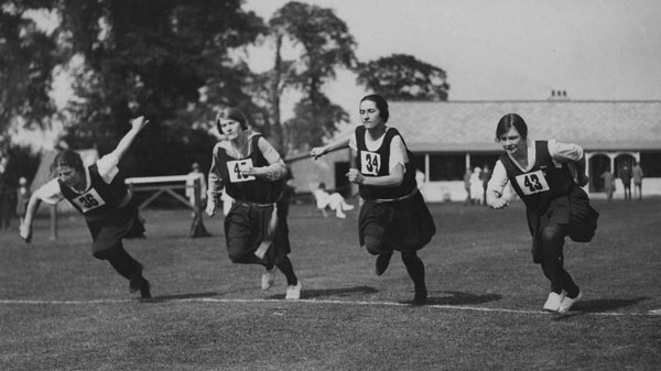 Four women run a race at LSE Sports Day, Malden Sports Ground, c1920s