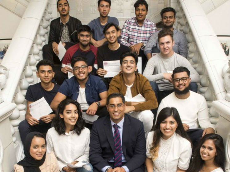 Mouhssin Ismail surrounded by students | LSE alumni | Newham Collegiate Sixth Form