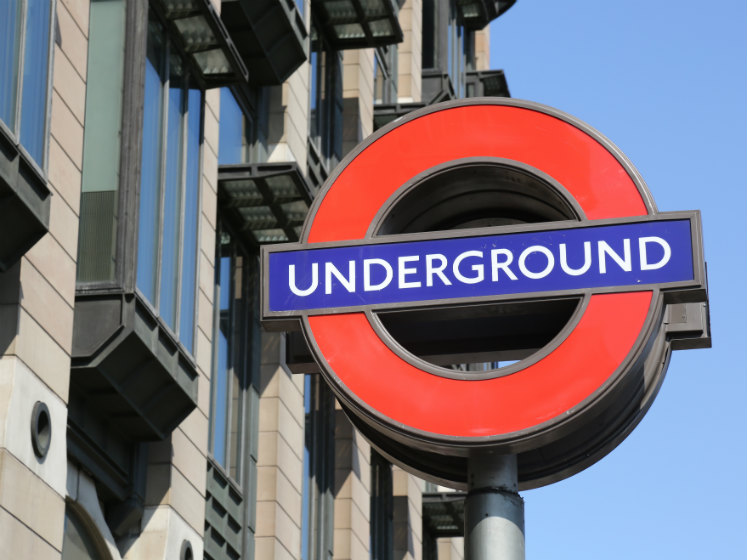 A red and blue sign of the london underground