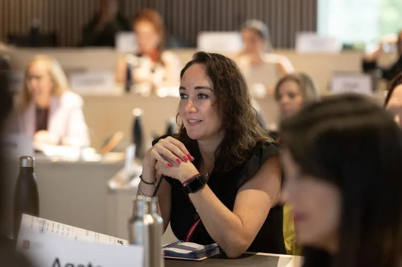 A brunette woman listening intently in the classroom Financial Statement Analysis and Equity Valuation