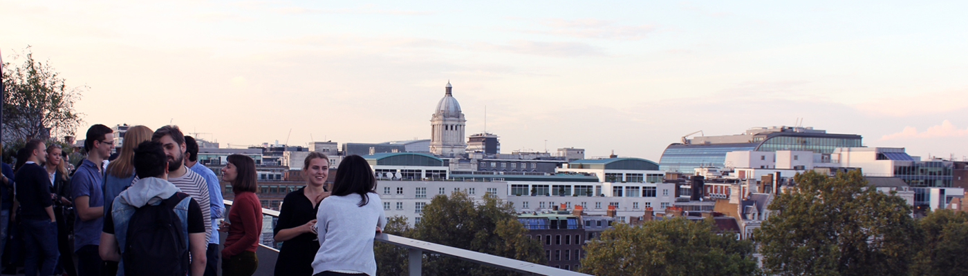 Students socialise on the NAB Terrace during Welcome Week with a view over the London skyline