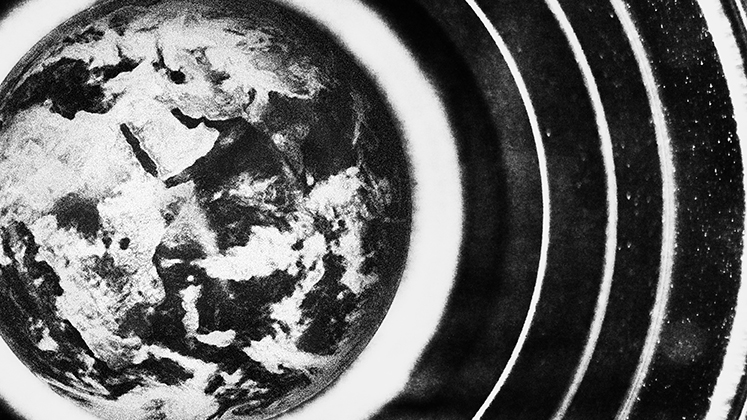Abstract black and white image of the earth in the centre of a camera lens with.