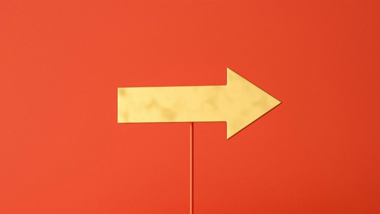 A yellow arrow pointing and set against a red background