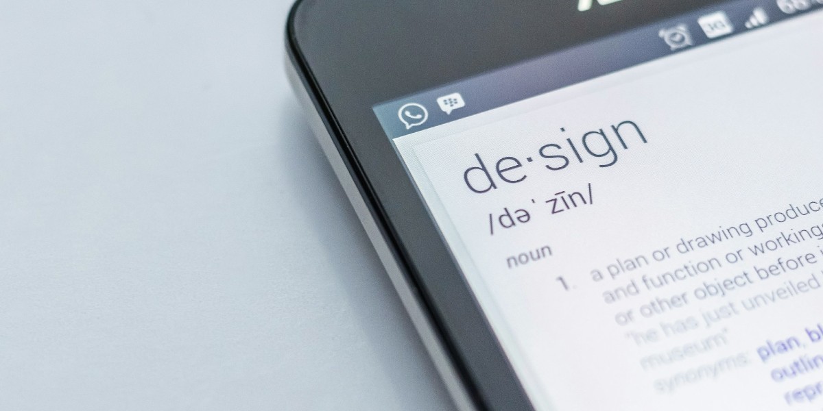 A phone with the word 'Design' on the screen above a definition