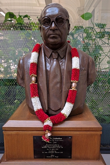 A bust of Ambedkar wearing glasses.