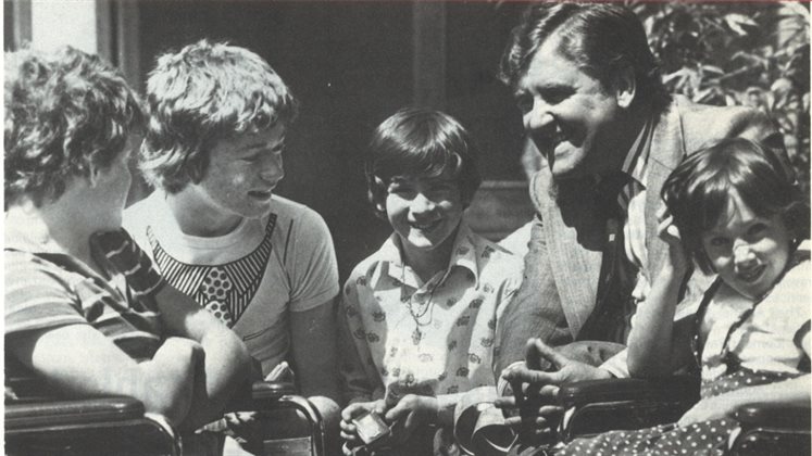 A photograph of Alf Morris MP with children dating to 1978, slightly cropped.