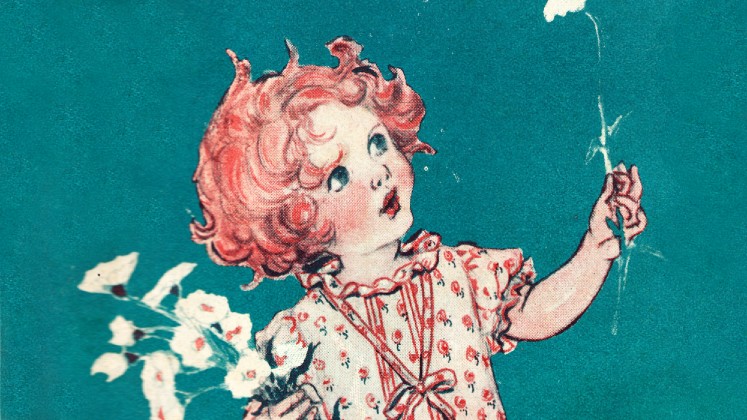 A red-headed girl in a dress looking upwards at the flower she is holding in her hand