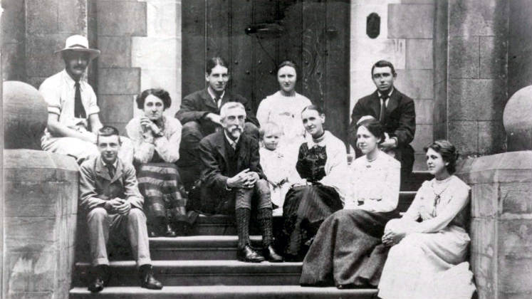 Charles Booth and his family sitting on some steps for a group photo.