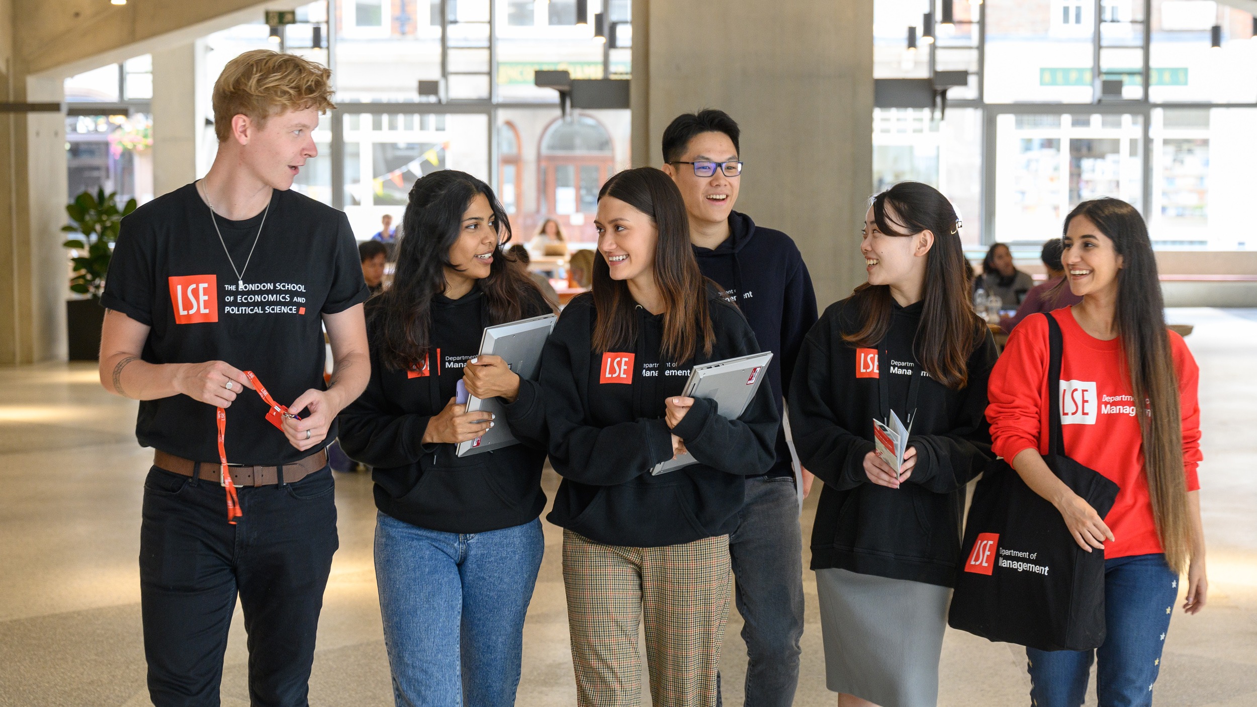 Six DoM students walking in Marshall Building