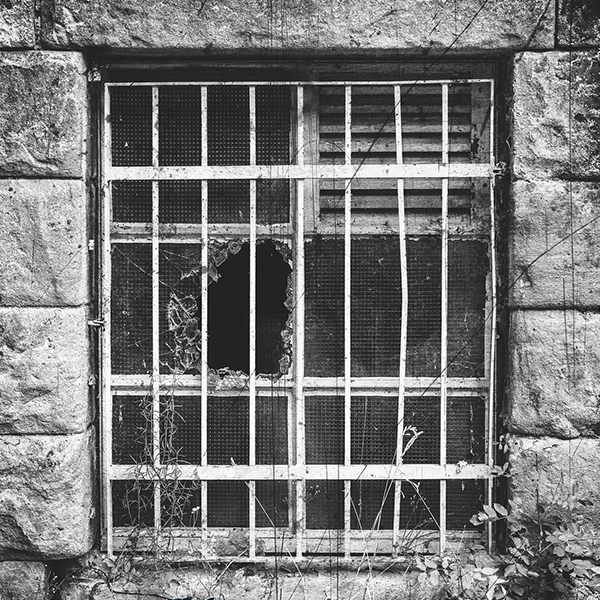 Image of a broken window in a prison