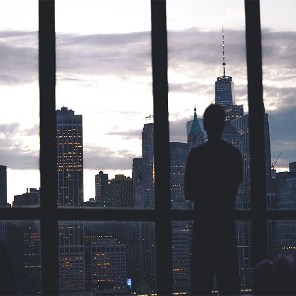 Silhouette of a man looking over the New York skyline