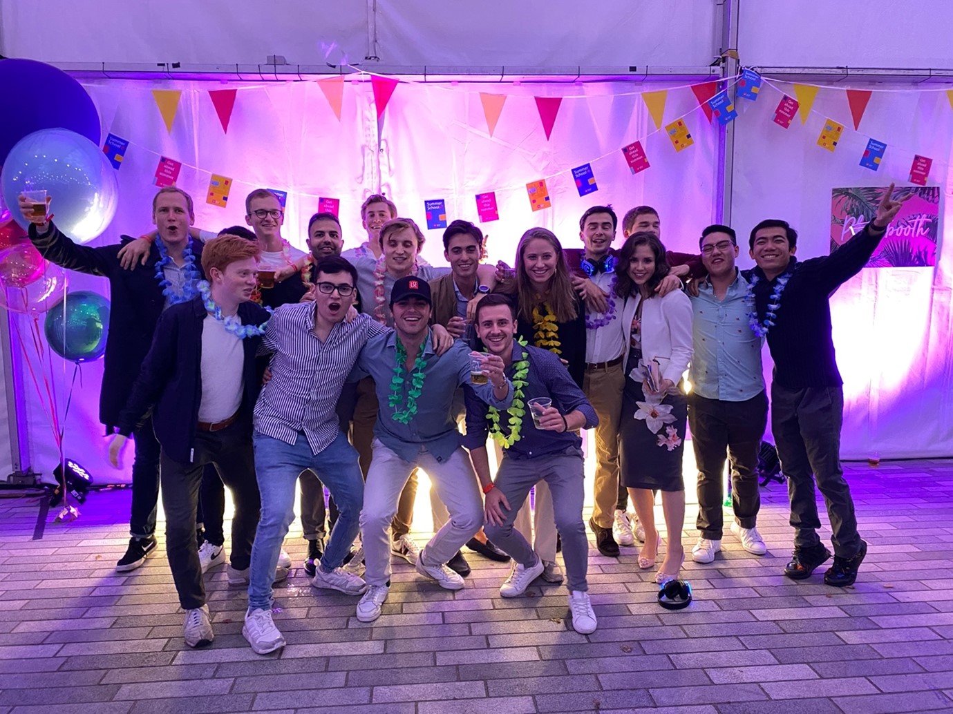 A group of young people smiling at a party.