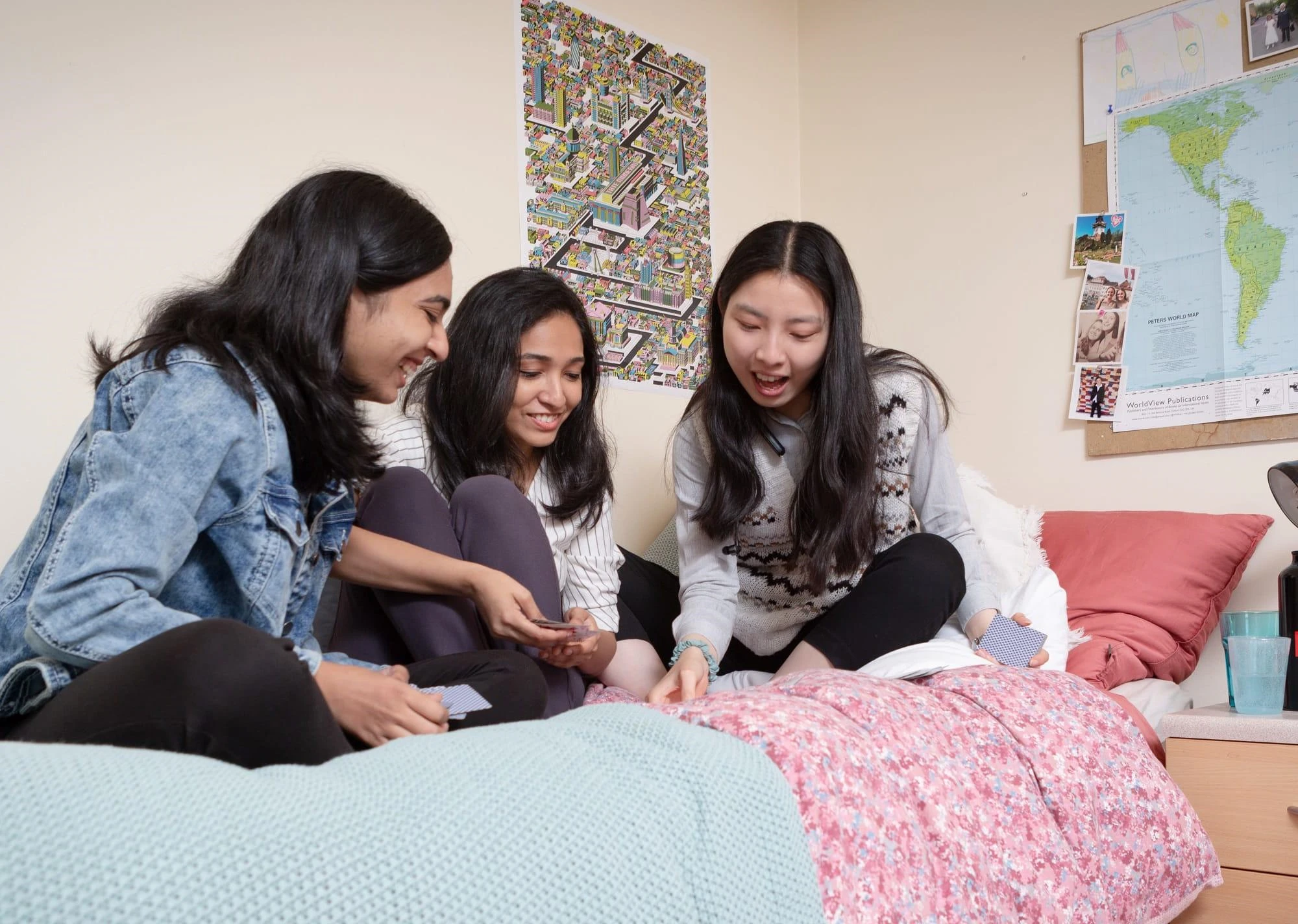 3 girls sitting on bed