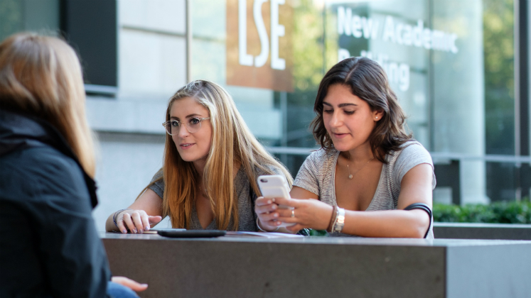 Students talk outside the New Academic Building