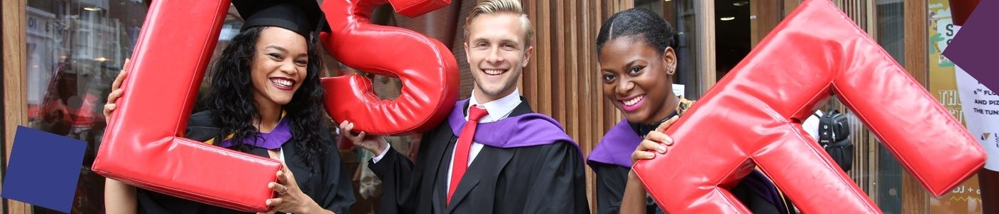 LSE graduates hold foam letters spelling 'LSE'